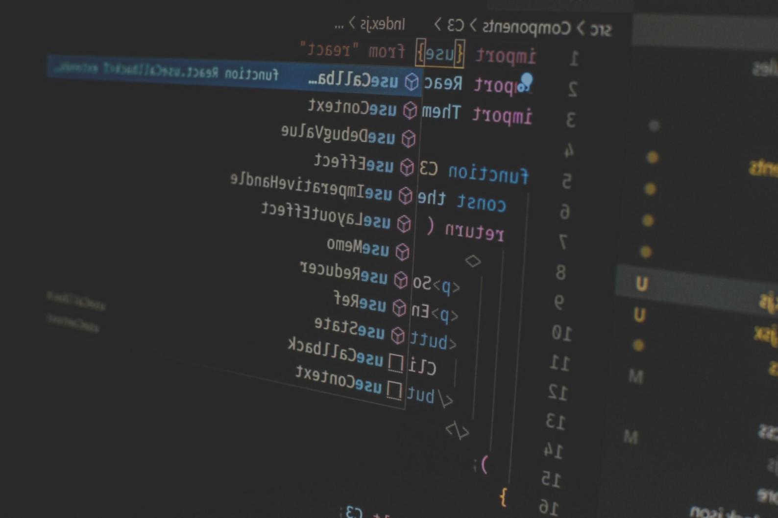 Developer reviewing blockchain code and network architecture on multiple screens
